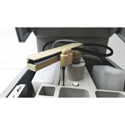 Beige robotic arm with black cable and metallic joint mounted on gray sebia hydraplus 2 autosampler for chromatography systems