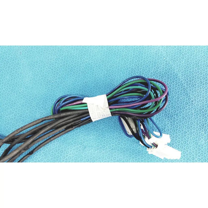 A bundle of black blue green and purple insulated wires tied with a white label in seiwa ferrite cores connectors wire harness cable