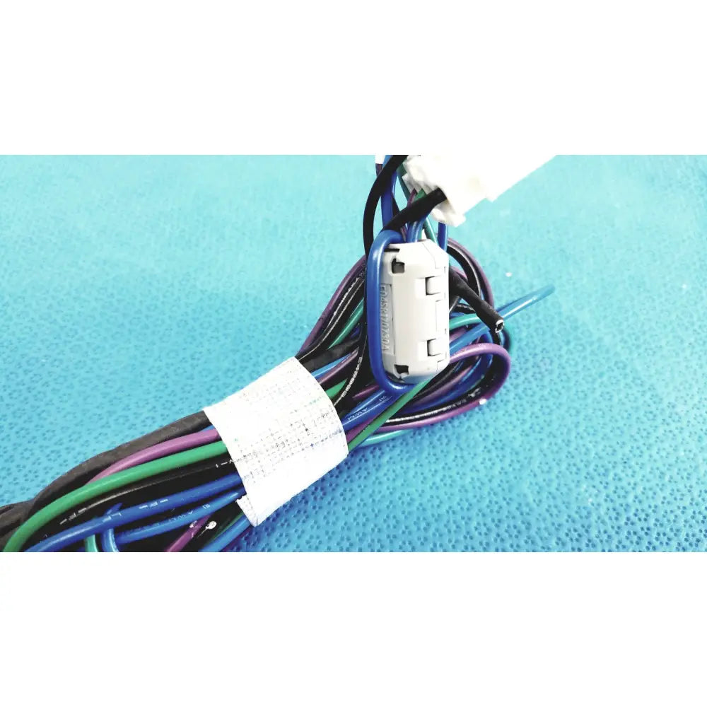 A white plastic seiwa ferrite cores connector with blue sleeve attached to multicolored connectors wire harness cable