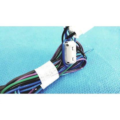 A white plastic seiwa ferrite cores connector with blue sleeve attached to multicolored connectors wire harness cable