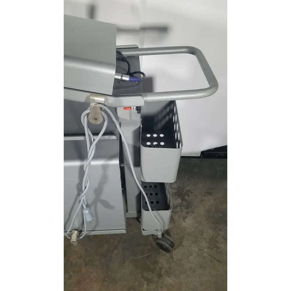 Gray metal medical cart with perforated side bins and handlebar for senorx cm3000 control module in encor breast biopsy system