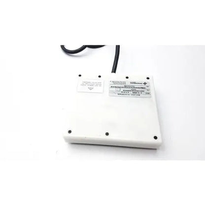 White rectangular power adapter with black cord and labels on the back of sensormedics 769259 interface box assembly