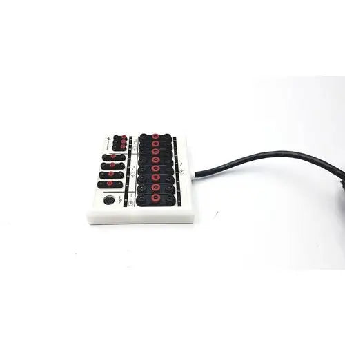 Sensor medics 769259 i/o interface box assembly featuring a white rectangular keyboard with black keys and red accents