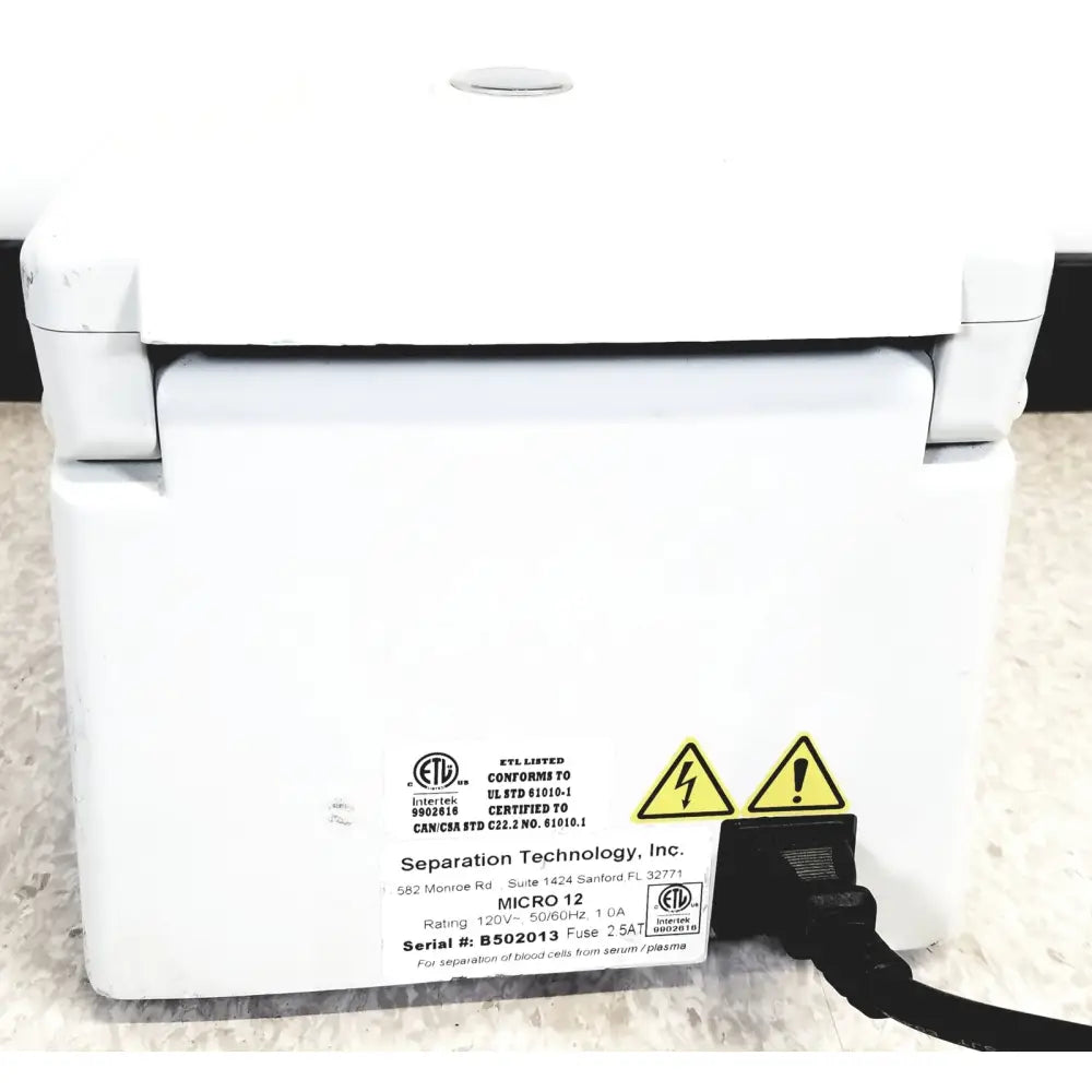 White plastic high performance microcentrifuge labeled micro 12 by separation technology inc for separation technology micro use