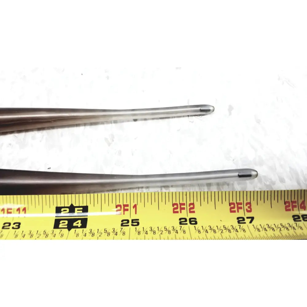 Set of 2 savary gilliard dilator cook with polished silver metallic tips and dark handles on a yellow measuring tape