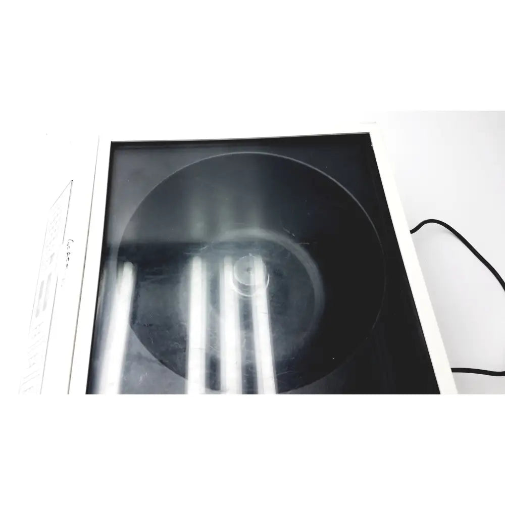 Black circular vinyl record displayed in a white-framed transparent case for shandon cytospin reuse medical device