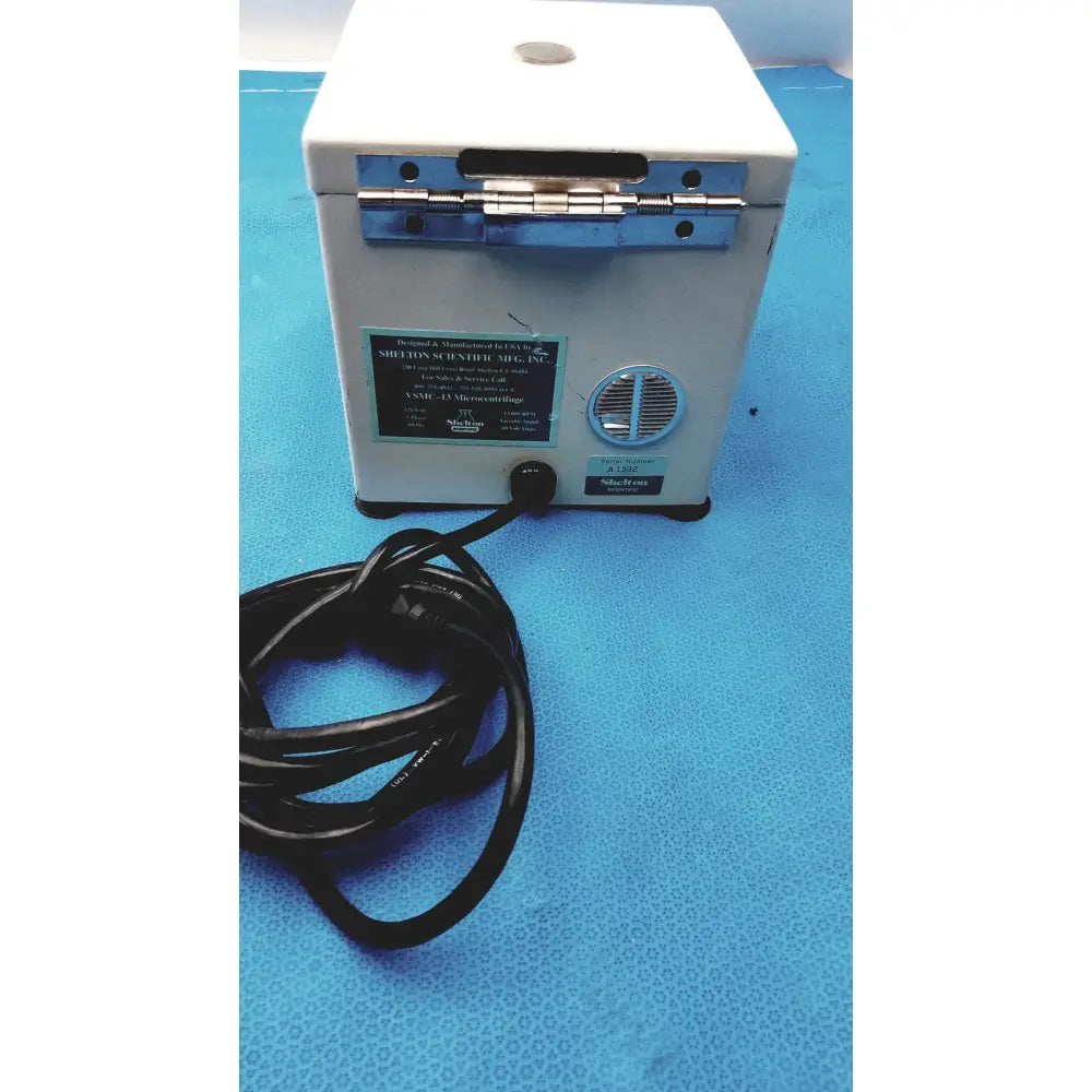 White rectangular benchtop laboratory centrifuge with silver hinges and vent by shelton scientific for compact lab use