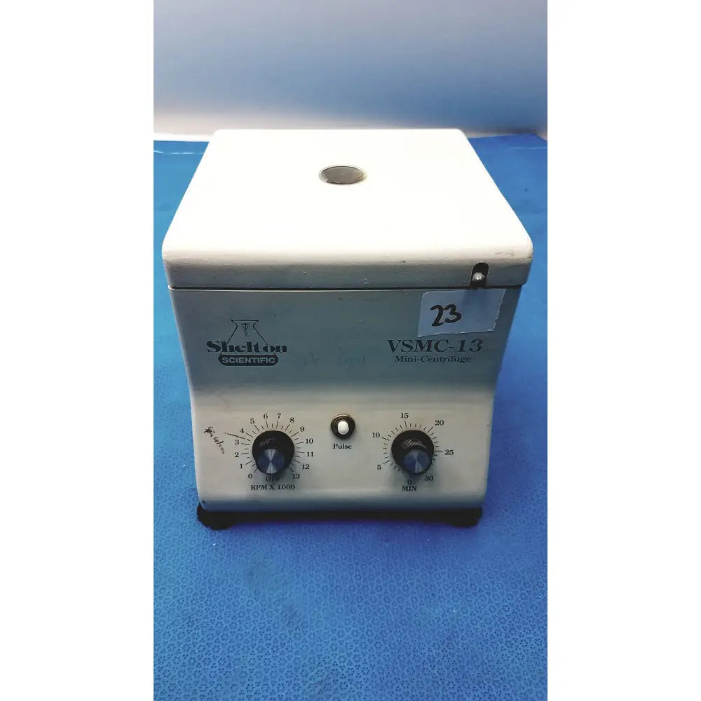 White and gray shelton scientific vsmc-13 benchtop laboratory centrifuge with rotary dials and pulse button on top