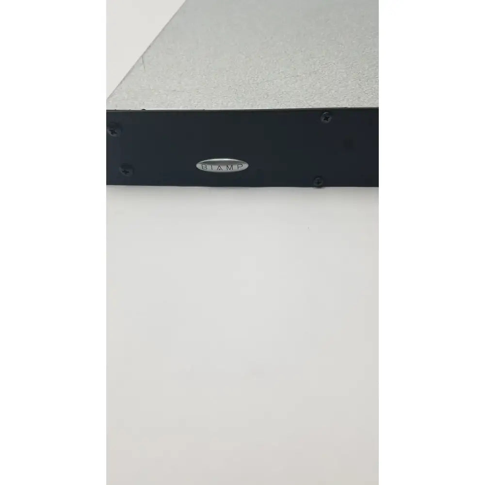 Black biaamp audio amplifier with silver textured top and four screws in shure scm800 rackmount professional mixer