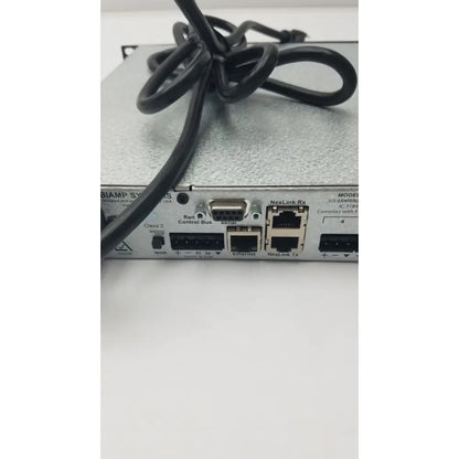 Black coiled cable resting on the back side of a silver shure scm800 rackmount professional 8 channel microphone mixer