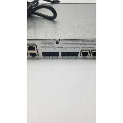 Silver metallic nexia tc network switch with multiple ethernet ports on the back of shure scm800 rackmount professional mixer