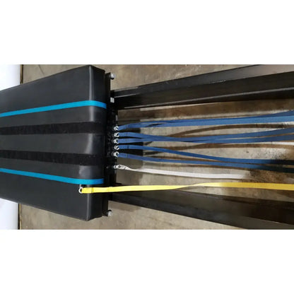 Black padded bench with blue and yellow straps on the side for shuttle recovery sport use