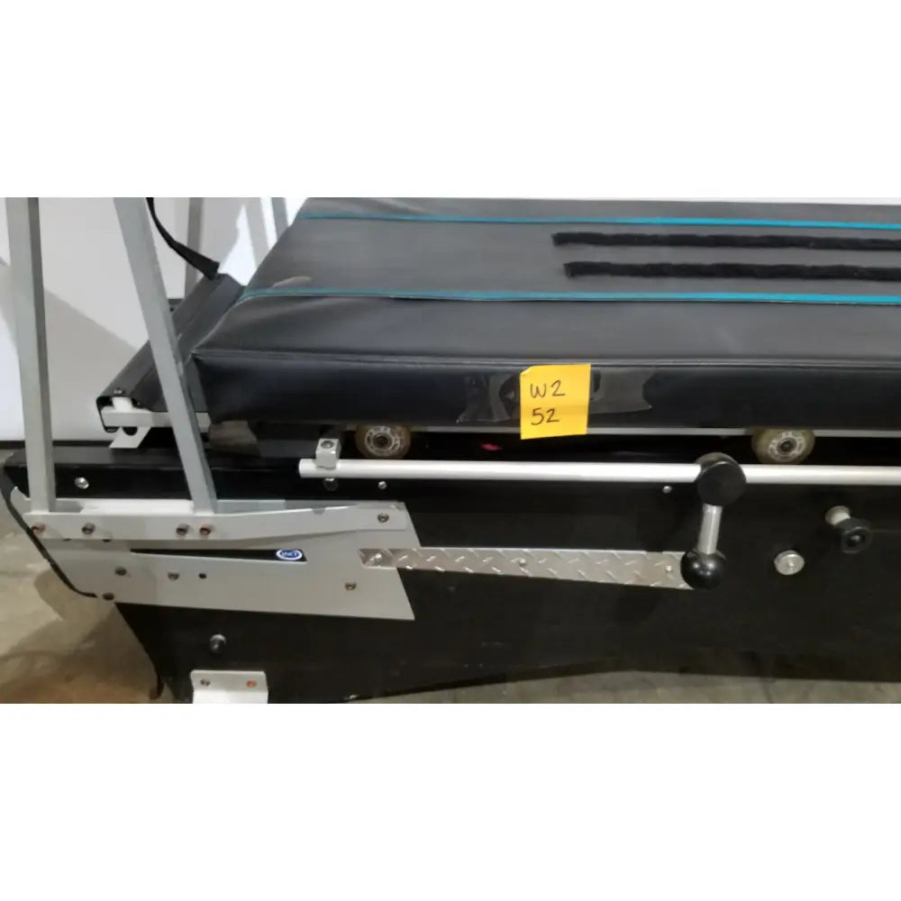Black treadmill with silver metal frame and textured running belt featuring wheels for shuttle recovery sport use