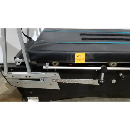 Black treadmill with silver metal frame and textured running belt featuring wheels for shuttle recovery sport use