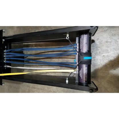 Black metal rigging harness with blue white and yellow webbing straps for shuttle recovery sport use