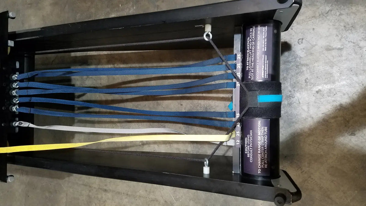 Black metal rigging harness with blue white and yellow webbing straps for shuttle recovery sport use