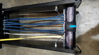 Black metal rigging harness with blue white and yellow webbing straps for shuttle recovery sport use