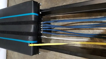 Black padded bench with blue and yellow straps on the side for shuttle recovery sport use