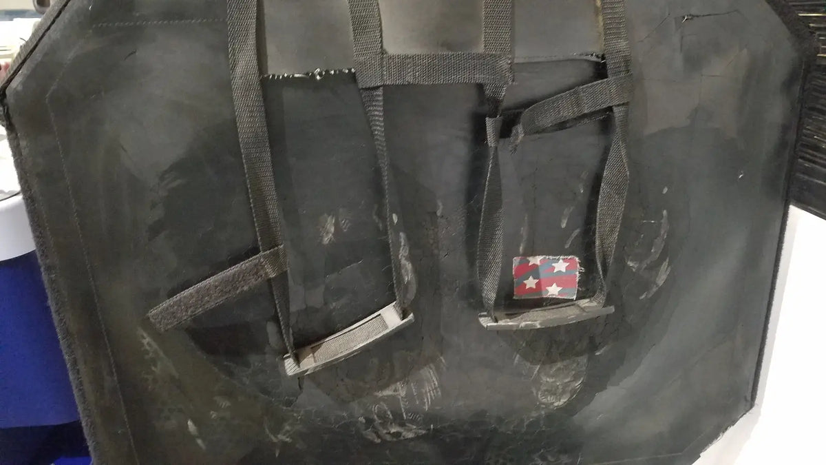 Black tactical vest with reinforced straps and red white and blue patch for shuttle recovery sport use