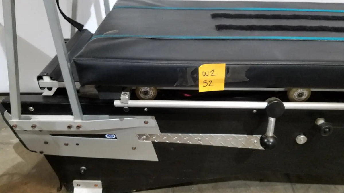 Black treadmill with silver metal frame and textured running belt featuring wheels for shuttle recovery sport use