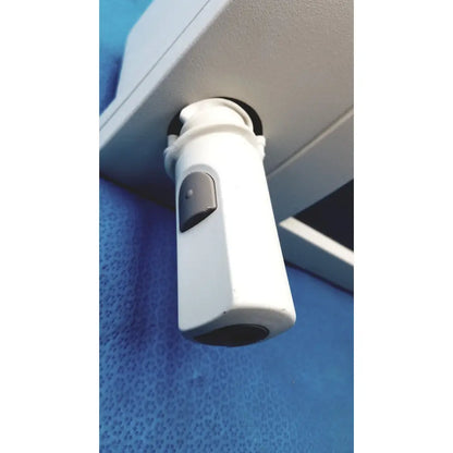 Siemens 07558831 ipx4 control console with white cylindrical security camera and gray button mounted under overhead surface