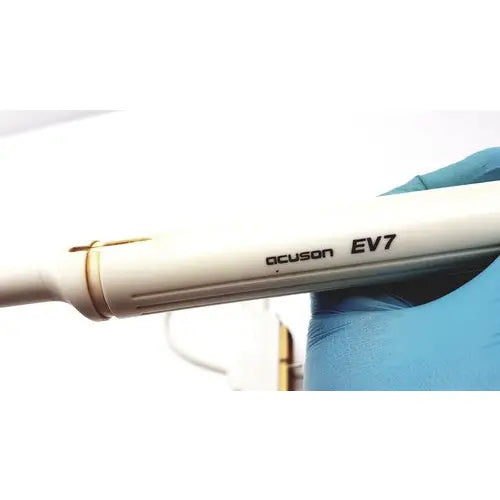 White siemens acuson ev7 linear probe ultrasound transducer held in a gloved hand for medical imaging use