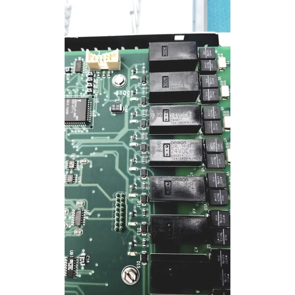 Black omron 24vdc relays mounted on green circuit board in siemens apogee automation 549-627 1210 modular controller