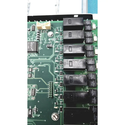Black omron 24vdc relays mounted on green circuit board in siemens apogee automation 549-627 1210 modular controller