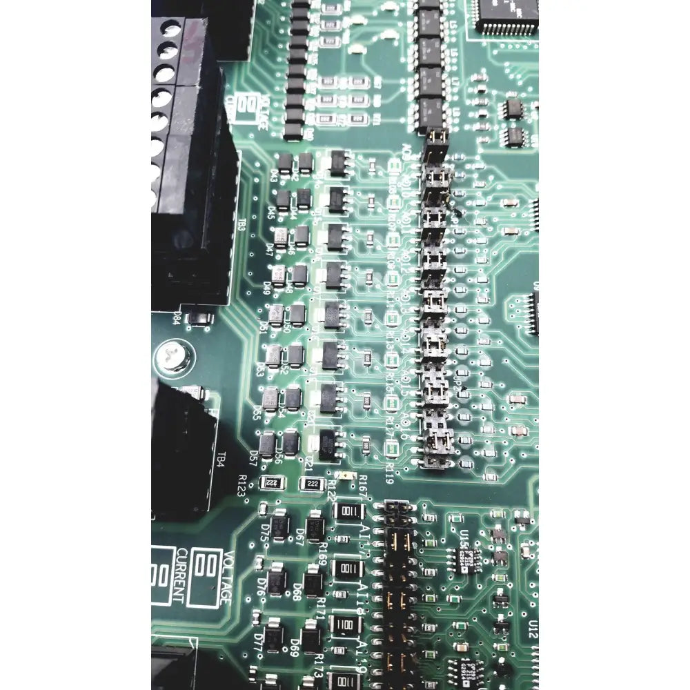 Green printed circuit board with black components and silver soldered connections in siemens apogee automation controller