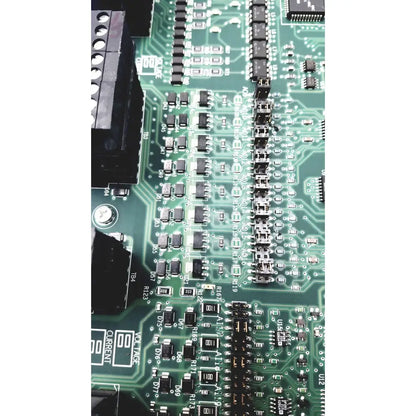 Green printed circuit board with black components and silver soldered connections in siemens apogee automation controller