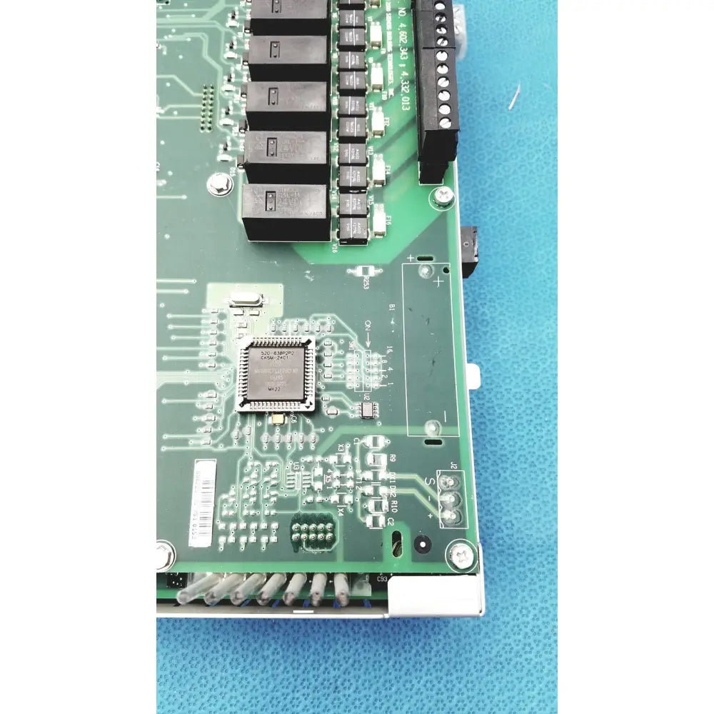 Green circuit board with black relays and central microchip for Siemens Apogee Automation 549-627 1210 controller series 200