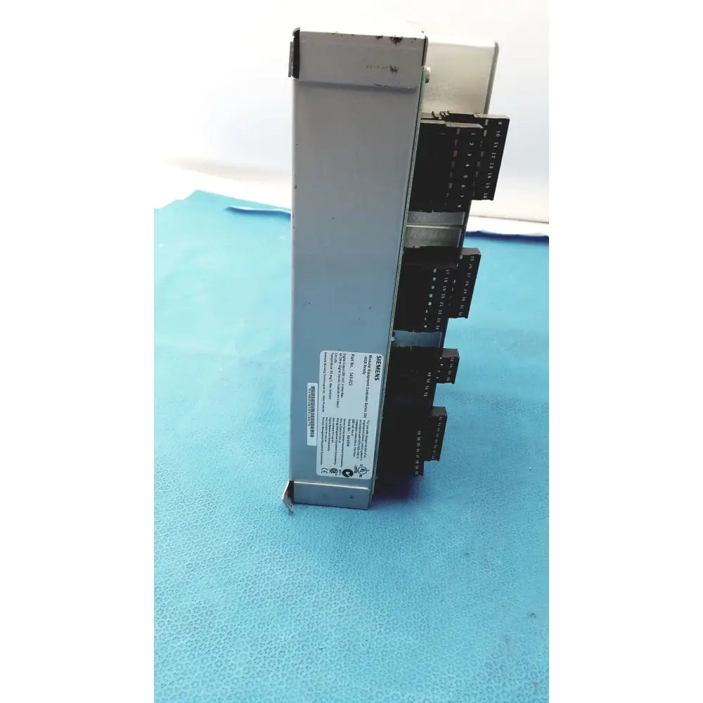 Silver metallic siemens apogee automation 549-627 1210 modular equipment controller with black terminal blocks and white label