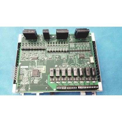 Green printed circuit board with black connectors inside metallic enclosure of siemens apogee automation controller