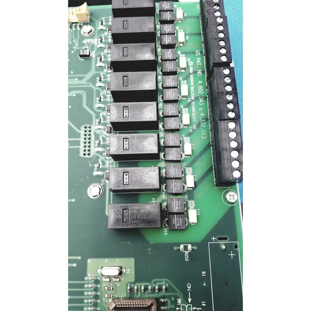 Black rectangular relays mounted on green circuit board in siemens apogee automation 549-627 1210 modular equipment controller