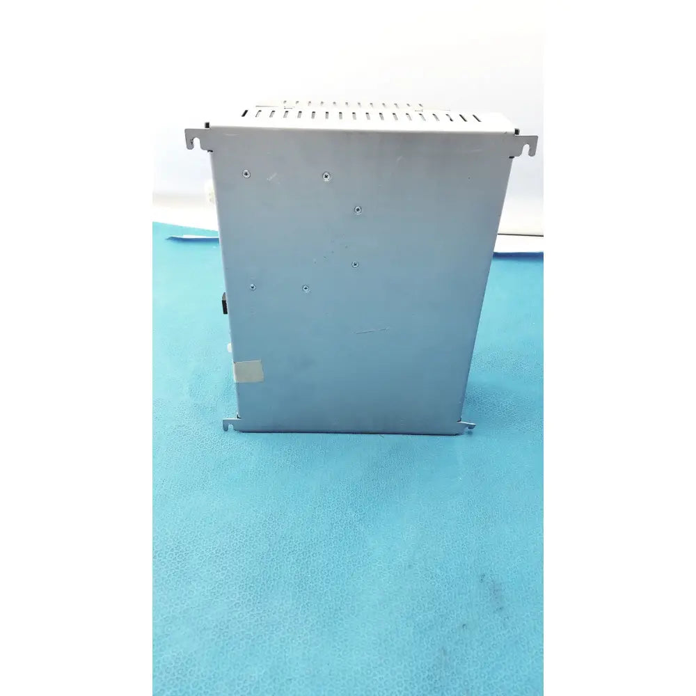 Silver metallic industrial power supply unit with perforated top panel and brackets for siemens apogee automation controller