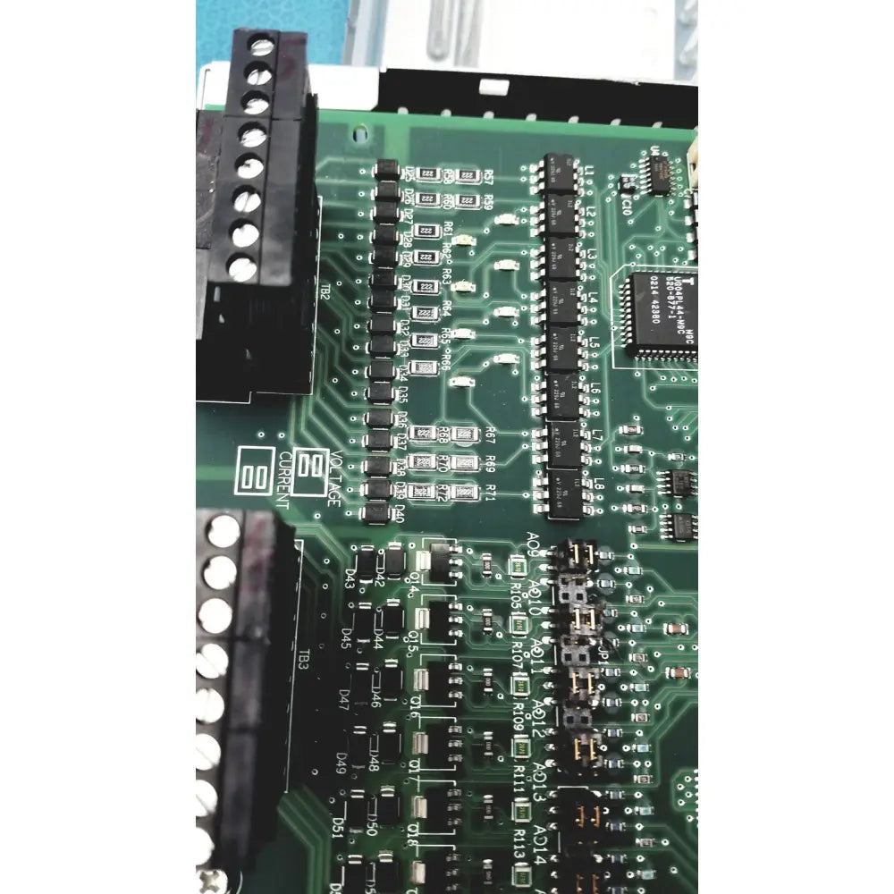 Green printed circuit board with black components and white labeling in siemens apogee automation 549-627 1210 controller