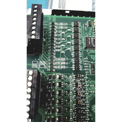 Green printed circuit board with black components and white labeling in siemens apogee automation 549-627 1210 controller