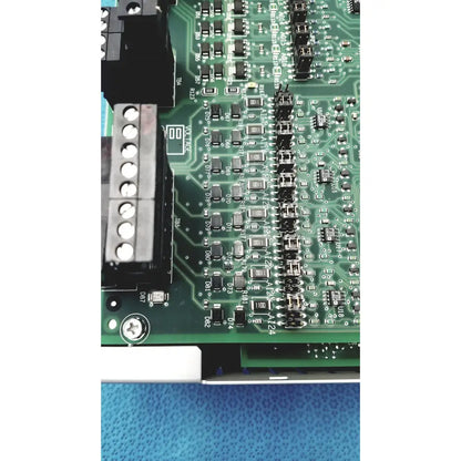 Green printed circuit board with black components and silver connectors of siemens apogee automation 549-627 1210 controller