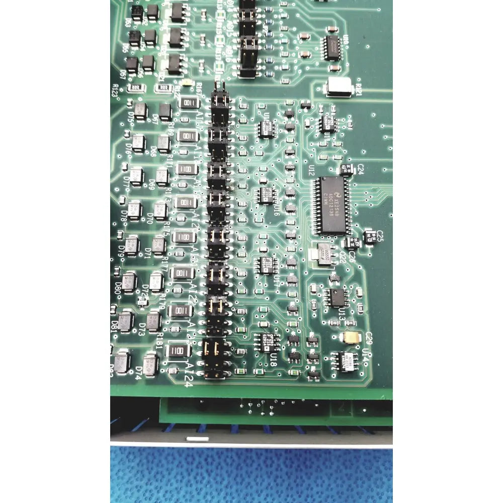 Green printed circuit board with black components and silver soldered traces in siemens apogee automation 549-627 1210 controller