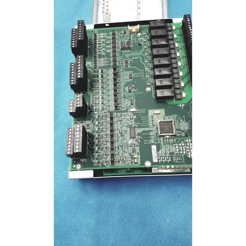 Green printed circuit board with black connectors and integrated circuits from siemens apogee automation controller series 200