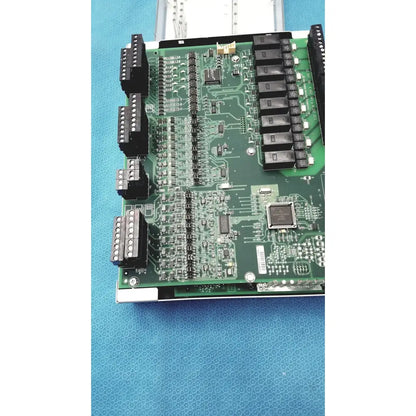 Green printed circuit board with black connectors and integrated circuits from siemens apogee automation controller series 200