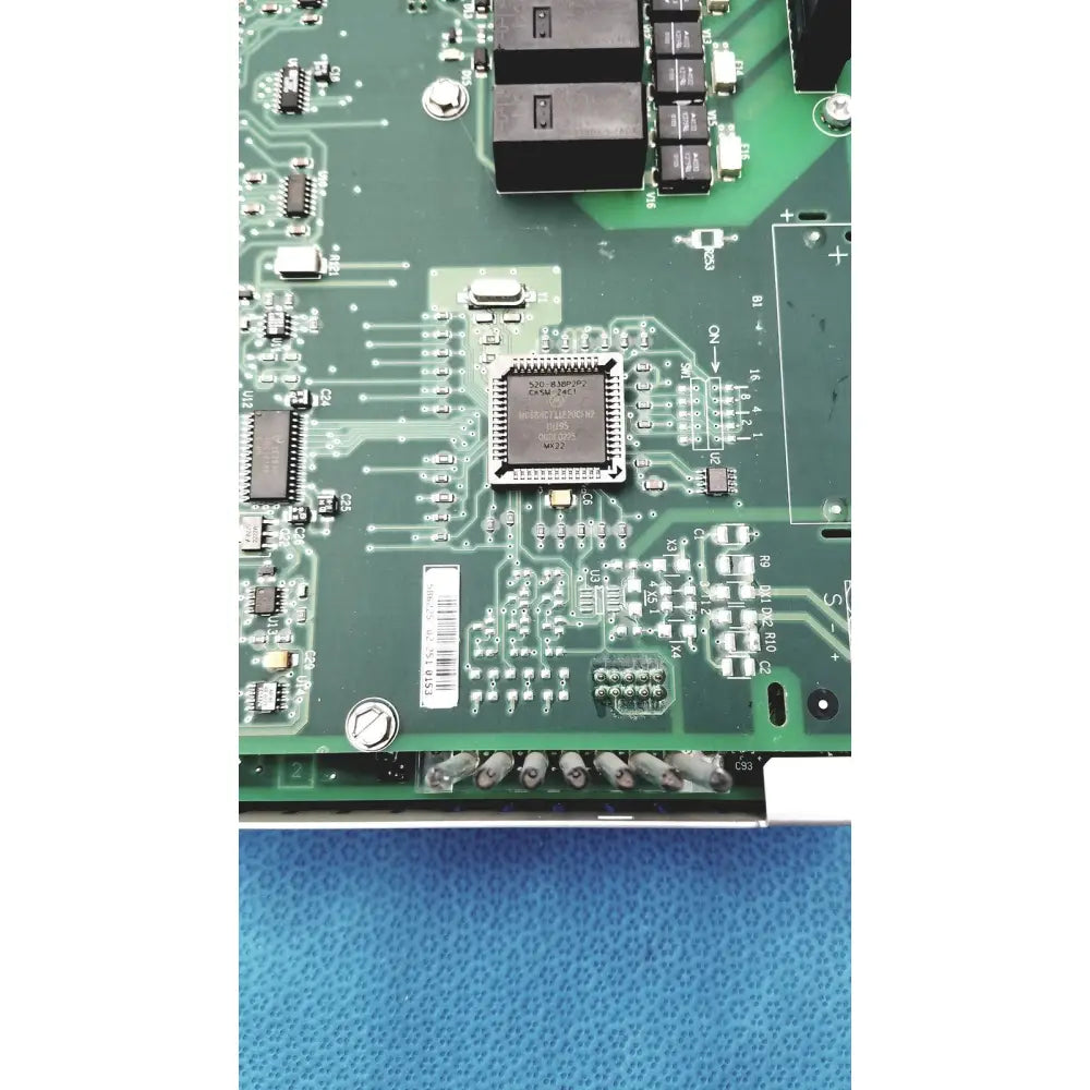 Green circuit board with central silver microchip and components in siemens apogee automation 549-627 1210 controller