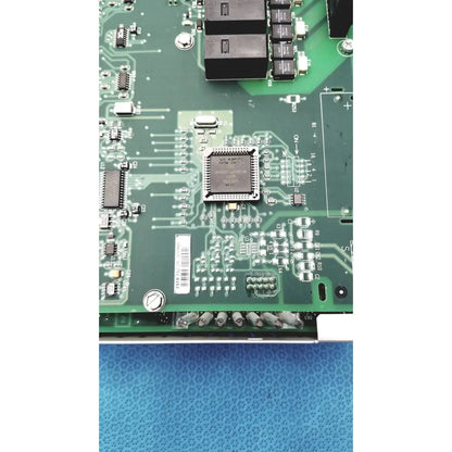 Green circuit board with central silver microchip and components in siemens apogee automation 549-627 1210 controller