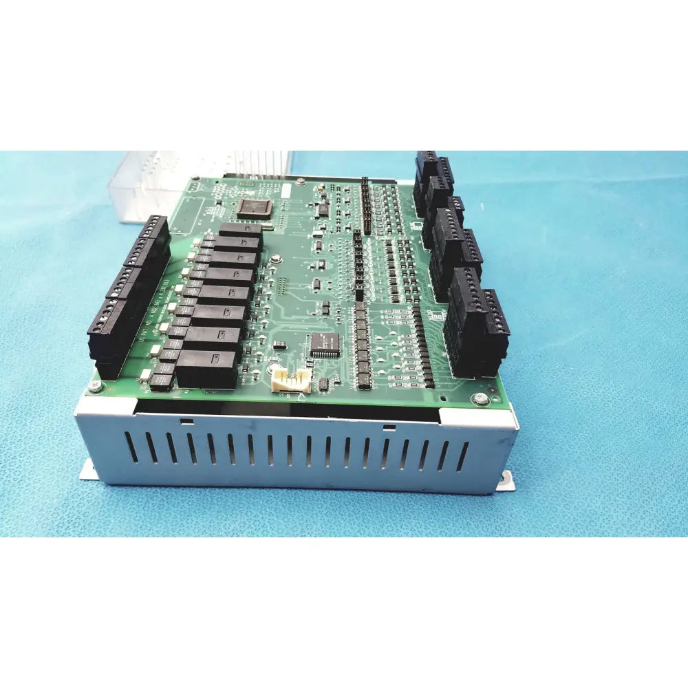 Green circuit board with black connectors and silver metal casing of siemens apogee automation 549-627 1210 modular controller