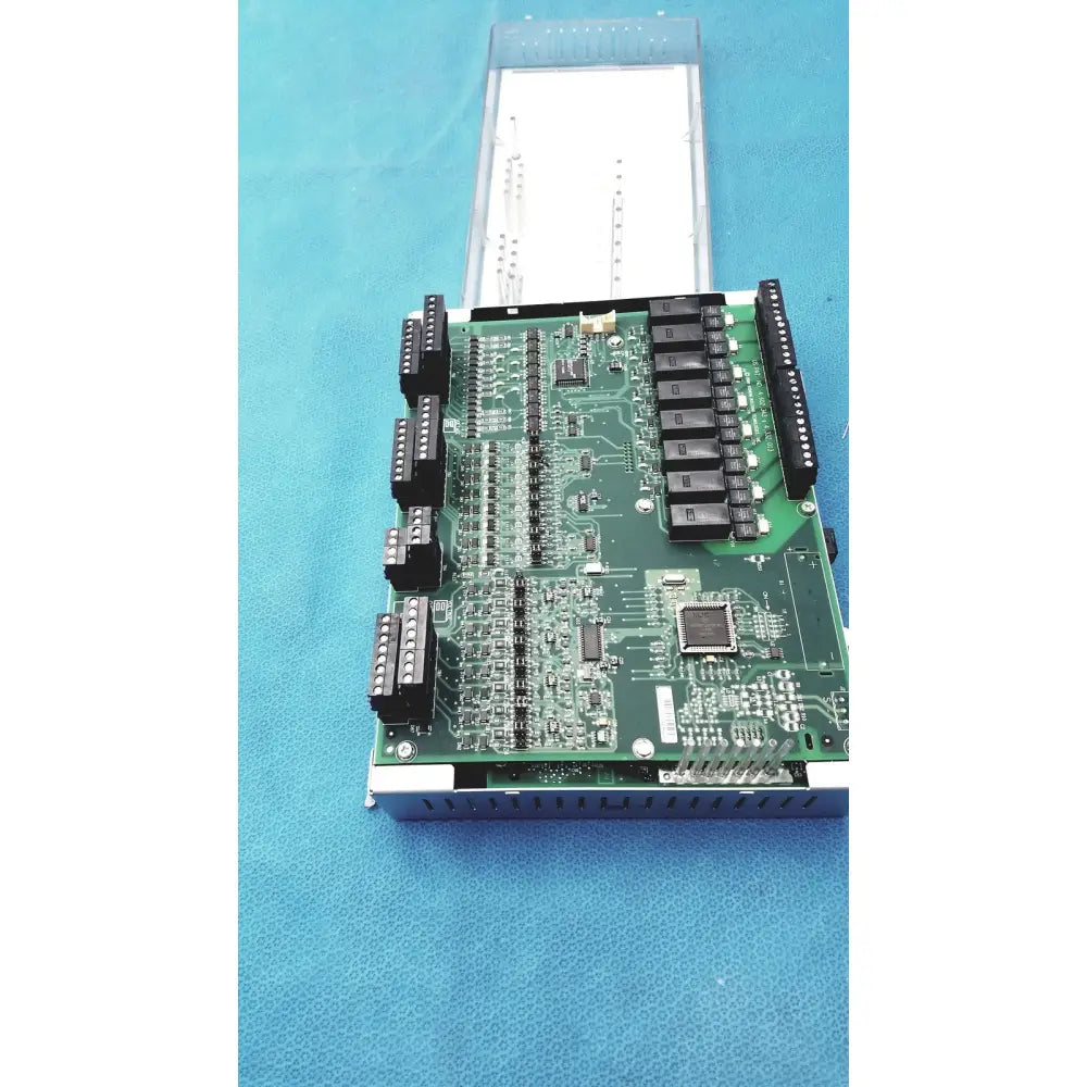 Green printed circuit board with black connectors and integrated circuits in siemens apogee automation 549-627 modular controller