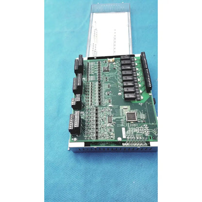 Green printed circuit board with black connectors and integrated circuits in siemens apogee automation 549-627 modular controller