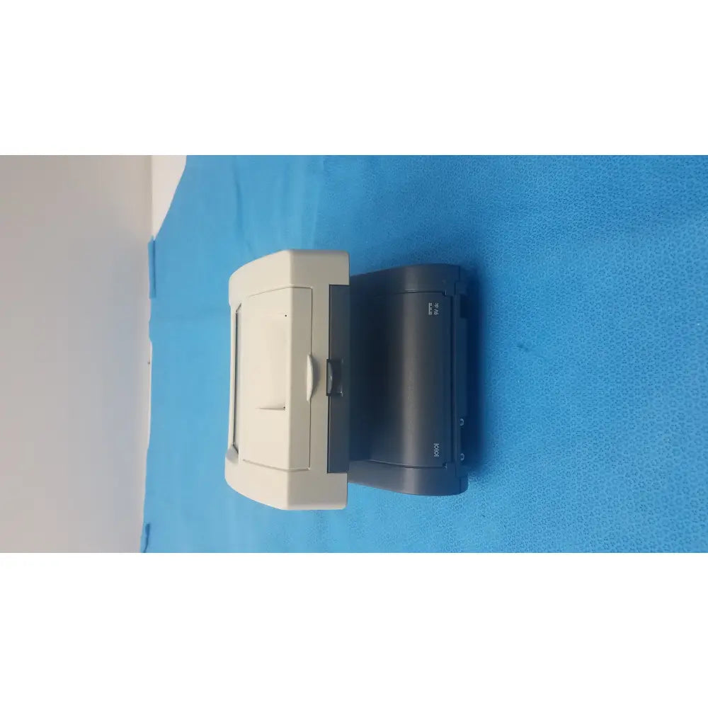 Beige and black hp laserjet printer with sleek compact design shown alongside siemens clinitek status urine analyzer