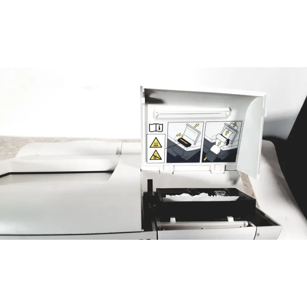 White multifunction printer with open panel showing instructional diagrams and toner compartment with white powder for siemens dca vantage analyzer
