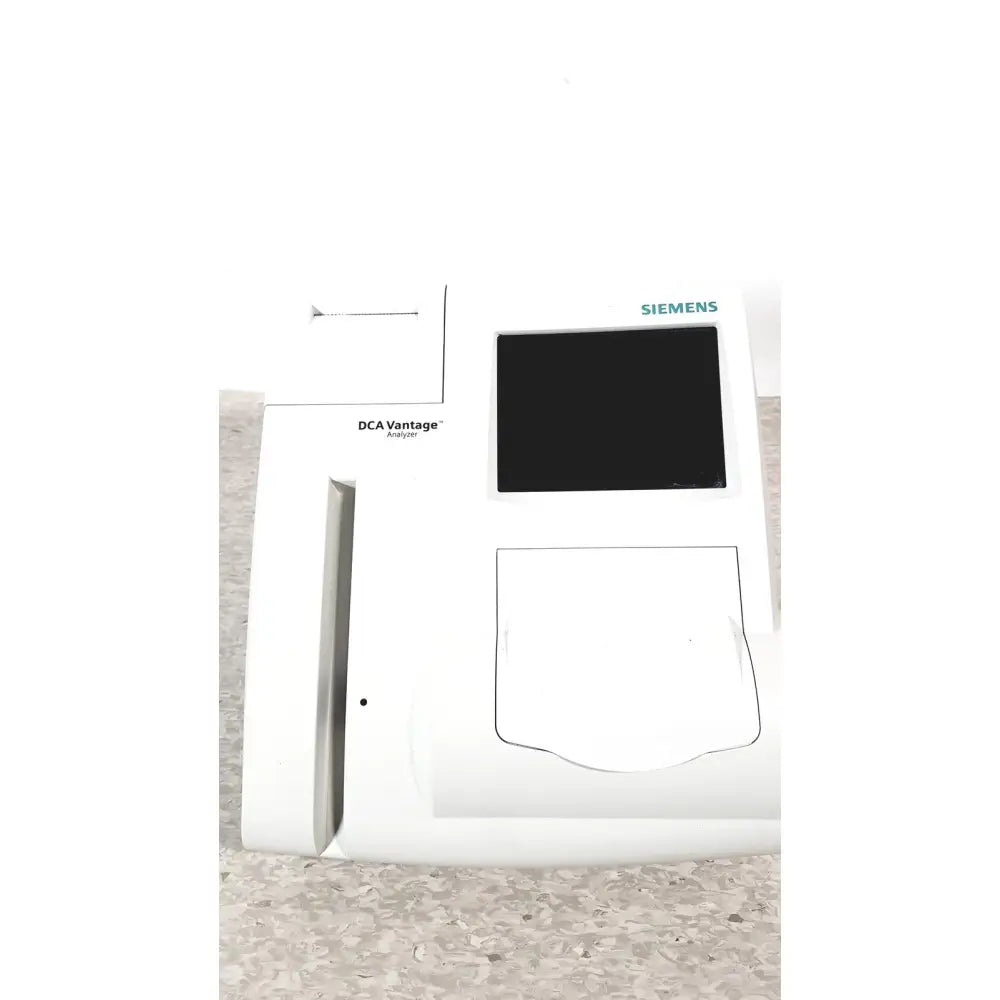 White Siemens DCA Vantage analyzer version 4.4 with black screen and rectangular sample slot for medical diagnostics