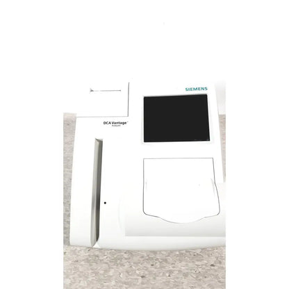 White Siemens DCA Vantage analyzer version 4.4 with black screen and rectangular sample slot for medical diagnostics